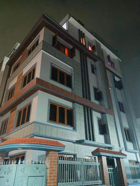 a tall building with a lot of windows at Durbar Home Apartments in Tribhuwan Airport