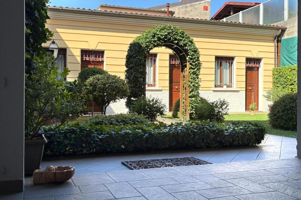 a yellow house with an arch in front of it at Il Giardinetto Rooms in Ferrara