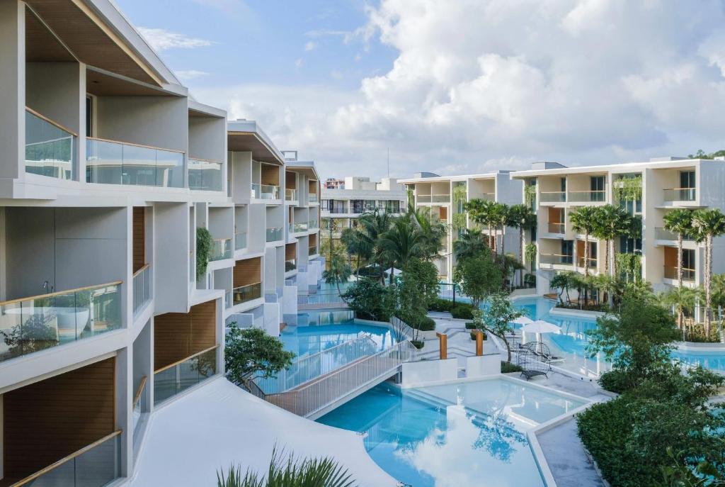 an aerial view of an apartment building with a swimming pool at Wyndham Grand Nai Harn Beach Phuket in Nai Harn Beach