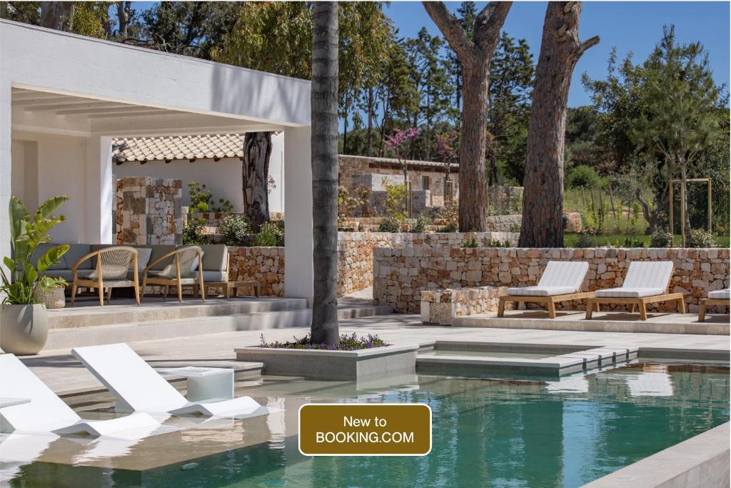 a rendering of a swimming pool in a backyard with chairs and a swimming poolvisor at Tenuta Legaro in Cozzana
