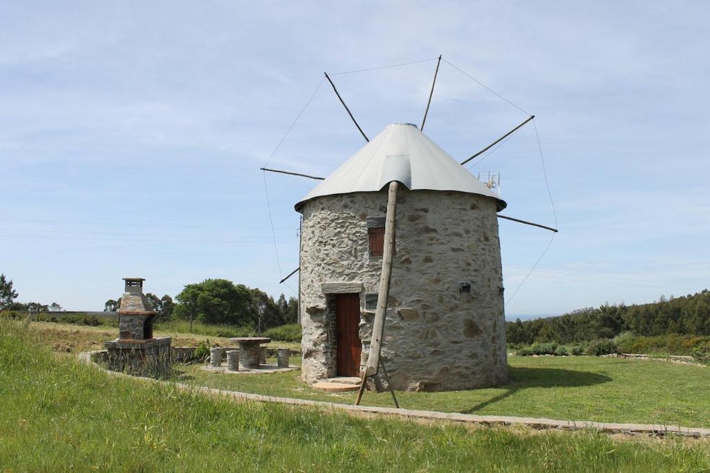 an old stone windmill in a grassy field at Penacova Moinho do Ligeiro near Coimbra in Penacova