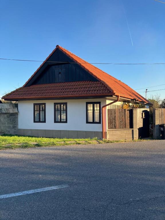 a house with an orange roof on the side of the road at Chata Prandorf in Devičany