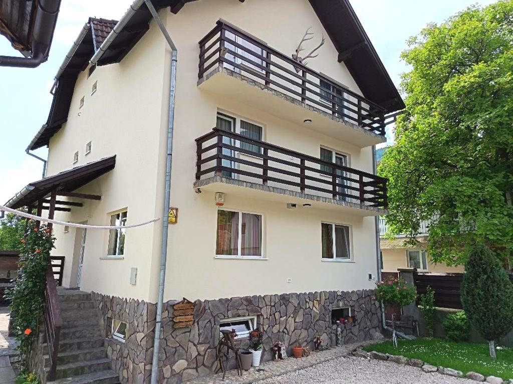 a large white building with a balcony on it at Casa Doi Crai in Zărneşti