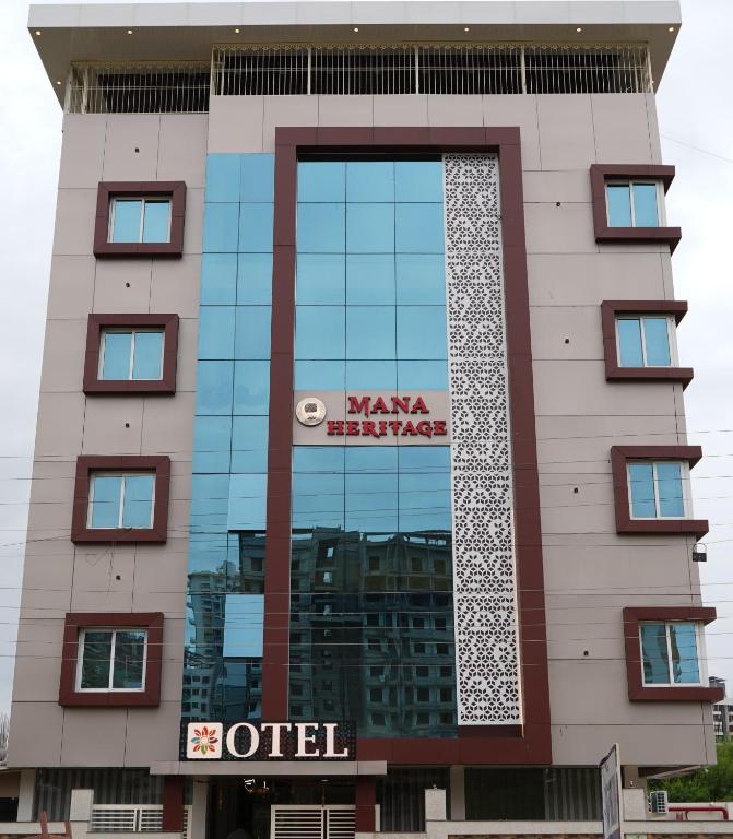 a building with a sign on the side of it at Hotel Otel Besa in Nagpur