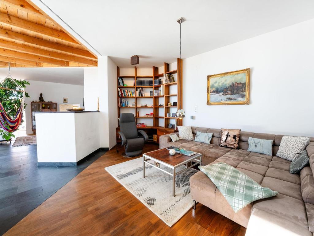 a living room with a couch and a table at Chalet Innerwald in Gnadenwald