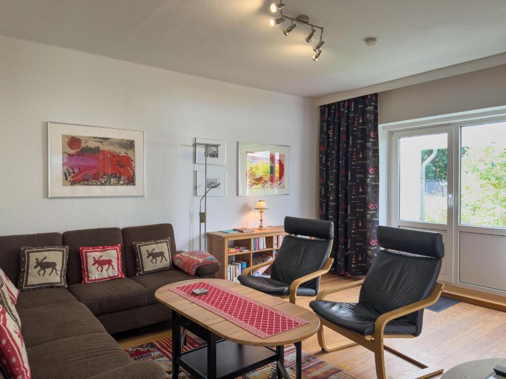 a living room with a couch and chairs and a table at Objekt-Nr 237 - Priwall - Mecklenburger Landstraße in Priwall