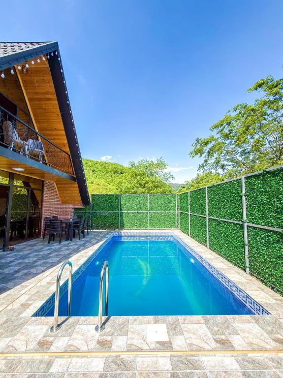 a swimming pool in front of a fence at Lerik Forest House in Lerik