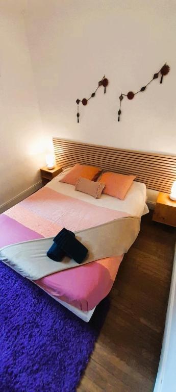 a bedroom with a bed with lights on the wall at Le Silodort - 7 pers - wifi - cour in Vatan