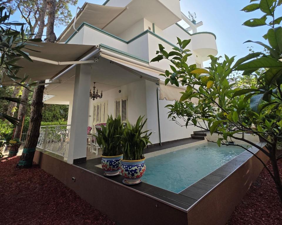 a villa with a swimming pool in front of a house at Villa Dyrrahu with Pool & Sea Access in Golem