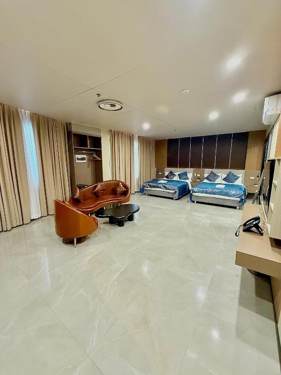 a hospital room with two beds and a couch at Skyport Hotel in Manila