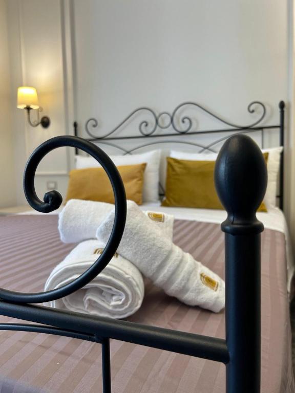 a pile of rolled up towels on a bed at PIAZZADUOMO b&b Stilo in Stilo