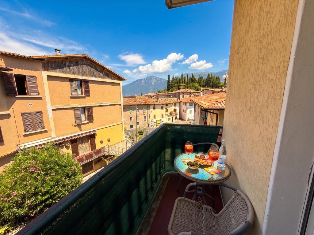 a balcony with a table and a view of a city at Casa Liver Pieve in Tremosine Sul Garda