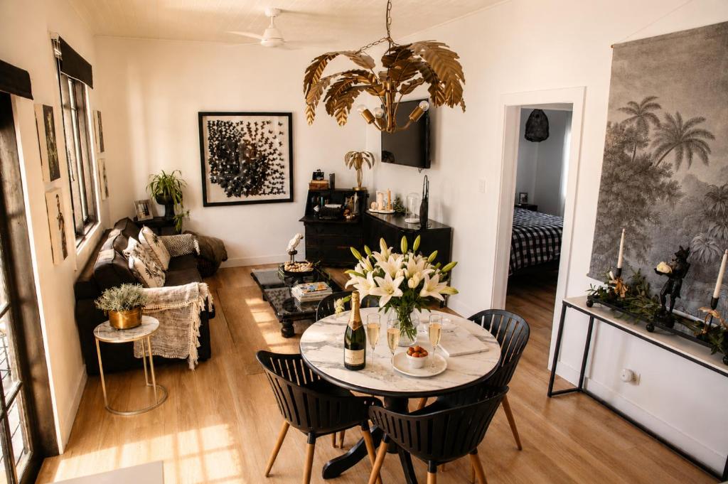 a living room with a table with flowers on it at Ebony & Ivory Villa in Nelson Bay