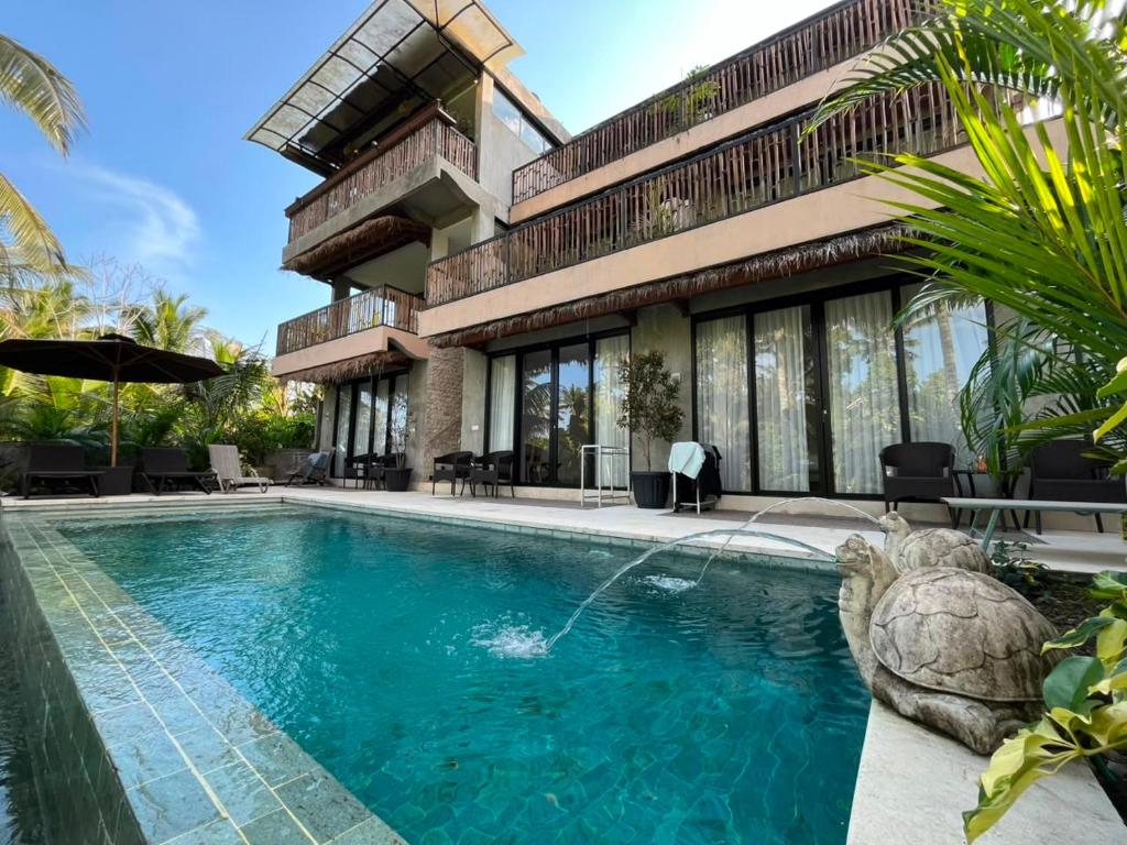 a house with a swimming pool in front of it at Bali View Ubud Hotel in Ubud