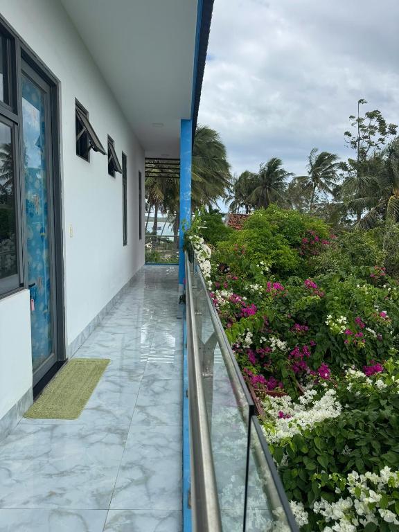 a balcony of a building with flowers and plants at Bee House in Long Thủy