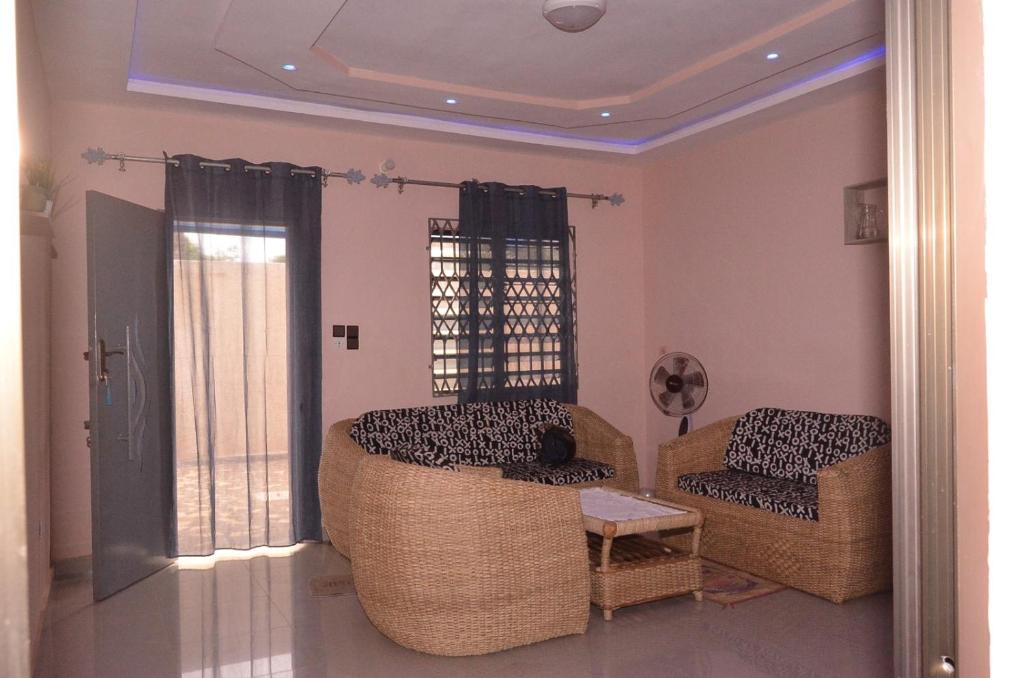 a living room with two chairs and a table at Résidence Saint Gall-H in Ouidah