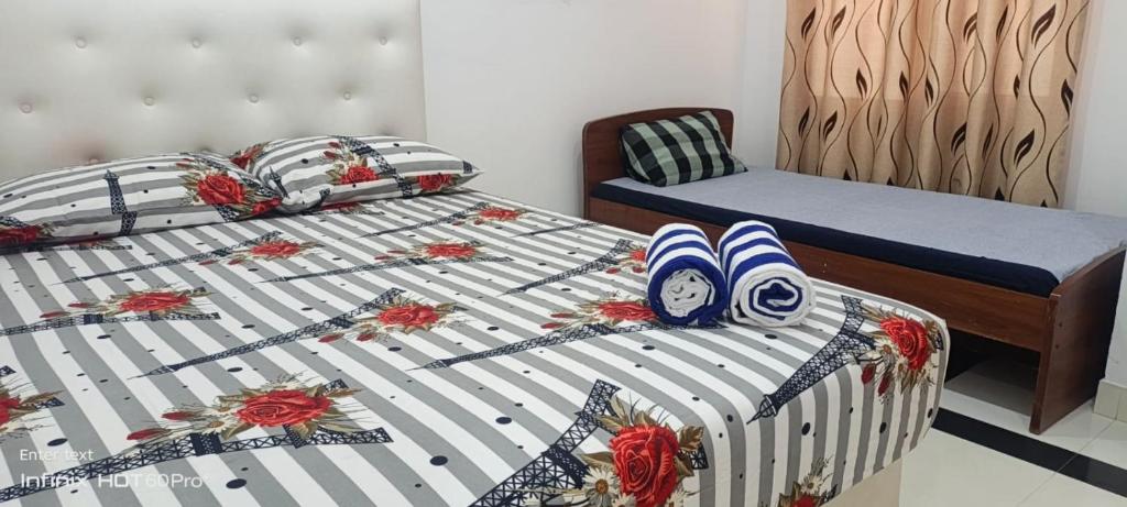 a bedroom with a bed with flip flops on it at Laya Neem Resort in Dambulla