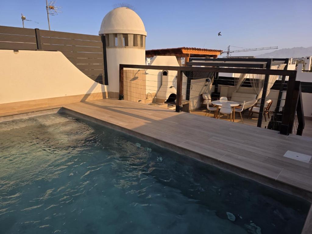 a swimming pool on the roof of a house at ÁTICO TERESA BORA PALM, PISCINA PRIVADA CLIMATIZABLE 250m playa in Vera