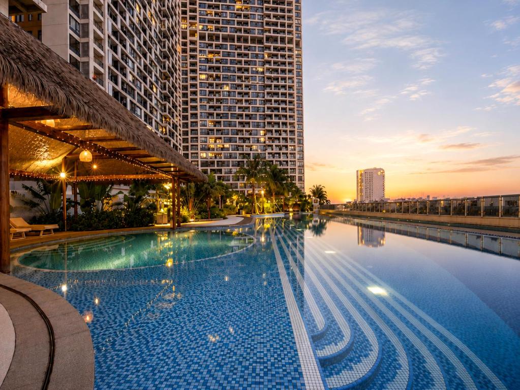 a swimming pool in a city with tall buildings at Pinnacle Moments Residence in Phnom Penh