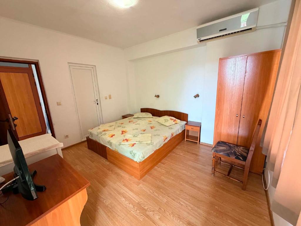 a bedroom with a bed and a tv in it at Guest House Dayana Double Room 6 in Ravda