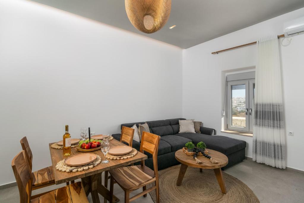 a living room with a table and a couch at Villa Balliu Panorama in Tripiti
