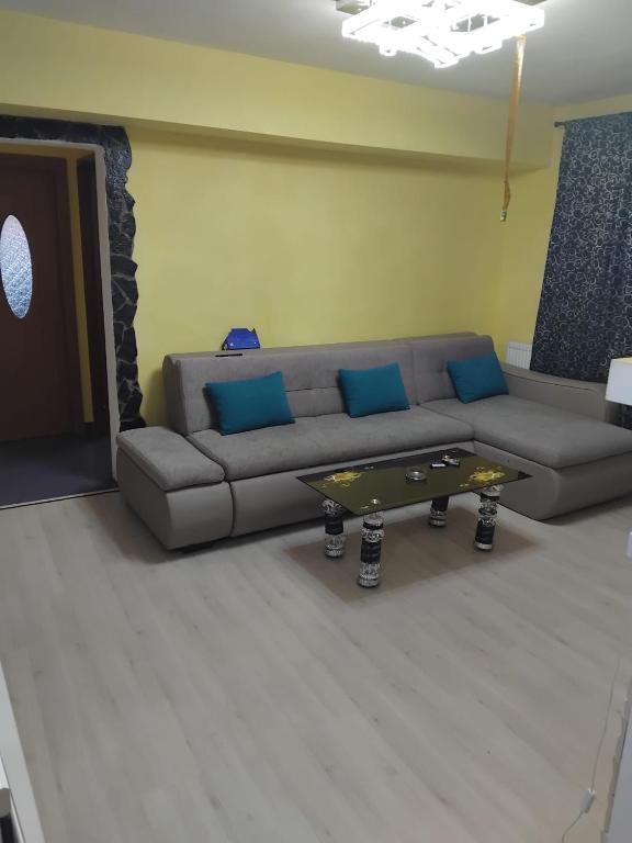 a living room with a couch and a coffee table at D&ATurism in Băile Govora