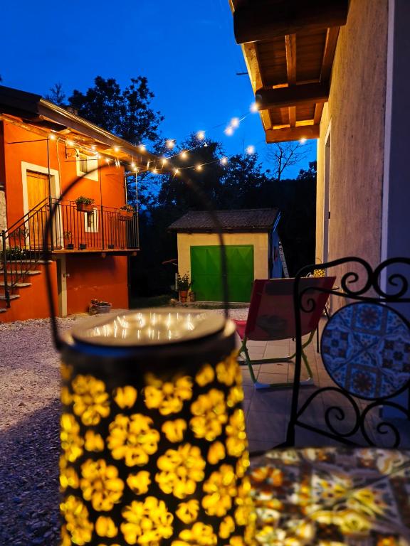 a vase filled with yellow flowers sitting on a patio at Il Boschetto della Valle Maira in Villar San Costanzo