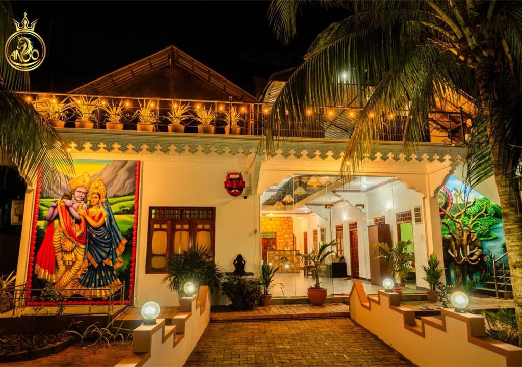 a house with a painting on the side of it at Anoo Garden Villa in Trincomalee