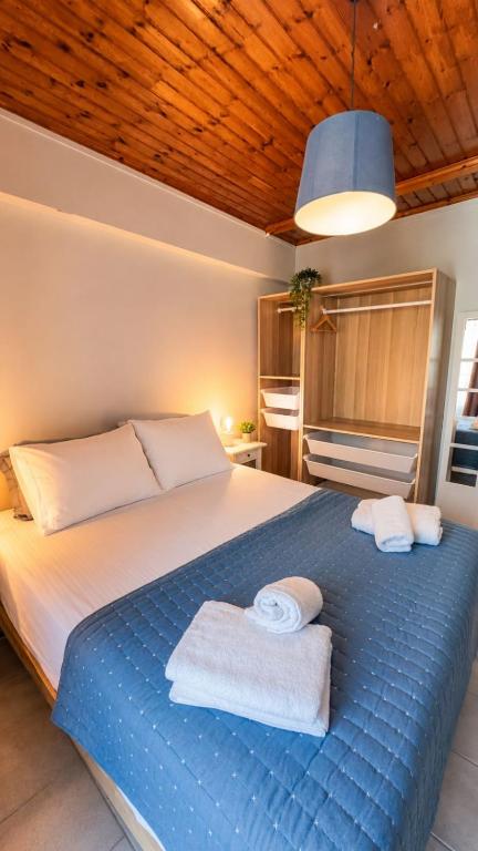 a bedroom with a large bed with towels on it at Thelxis Room in Nydri