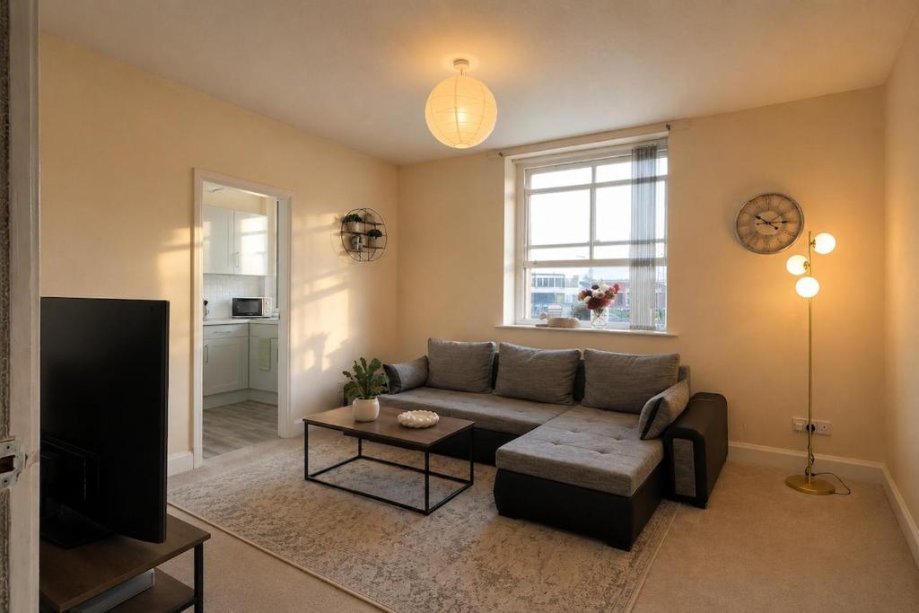 a living room with a couch and a table at Cloud Quarters 4 in Huddersfield