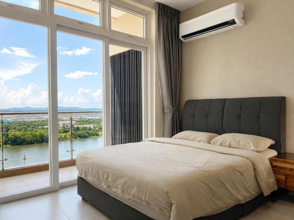 a bedroom with a large bed and a large window at Blue Cove Riverine Diamond Kuching in Kuching