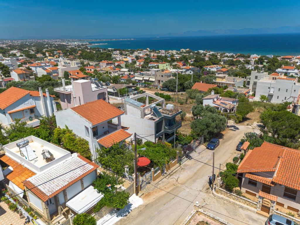 an aerial view of a city with houses and the ocean at Artemis Breeze in Artemida
