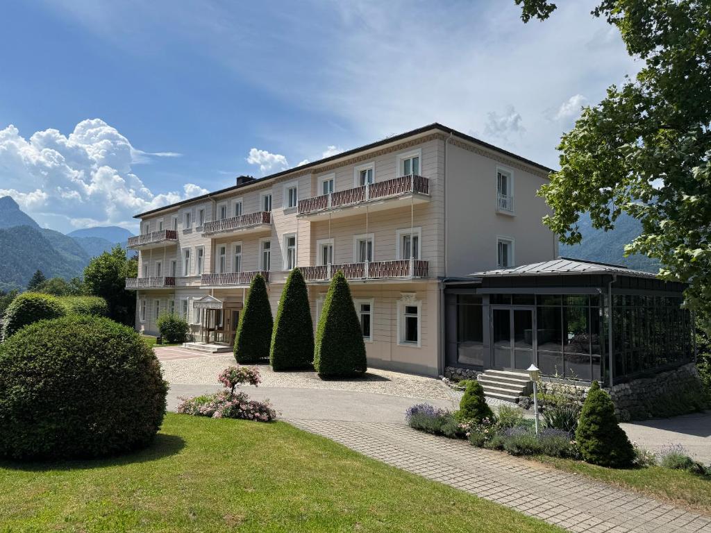 a large building with a garden in front of it at Das Alpina in Bad Reichenhall