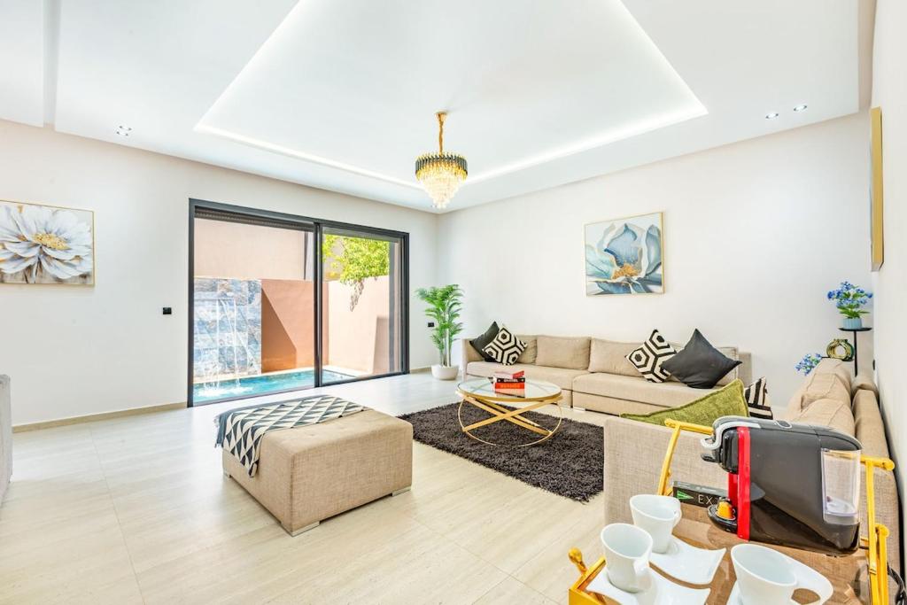 a living room with a couch and a tv at Villa Horizon Premium - Private Pool - Fully Renovated - Marrakech in Marrakesh