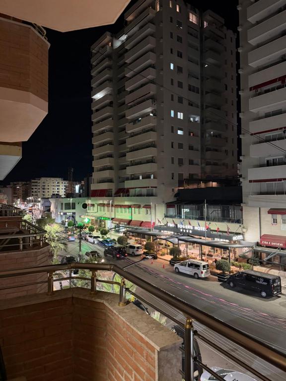 a city street at night with tall buildings at Shengjin Central Apartments in Shëngjin