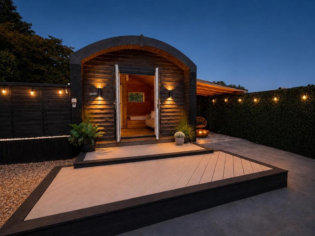 a backyard with a small house with a patio at The Nest @The Outside Inn in Mountfield