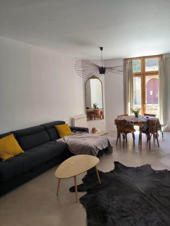 a living room with a couch and a table at Furnished T2 apartment in Luchon