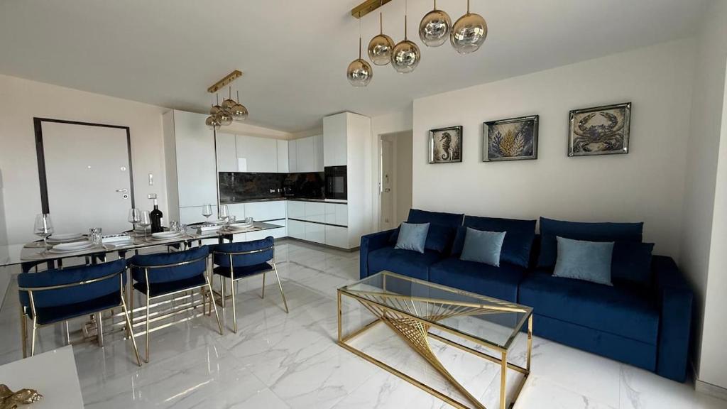 a living room with a blue couch and a table at Laguna Blu in Montepaone Lido