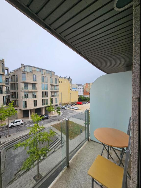 a balcony with a table and a view of a street at Os limoeiros do cura in Foz