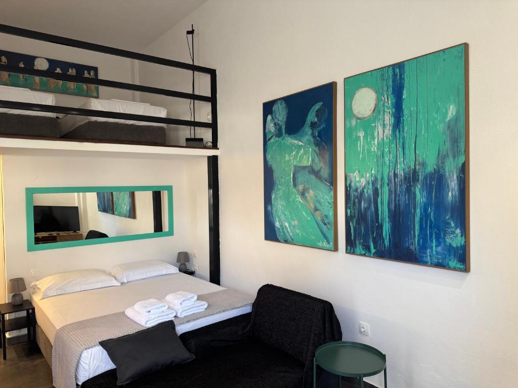 a bedroom with a bed and a bunk bed at Cosy Stay in Platamonas