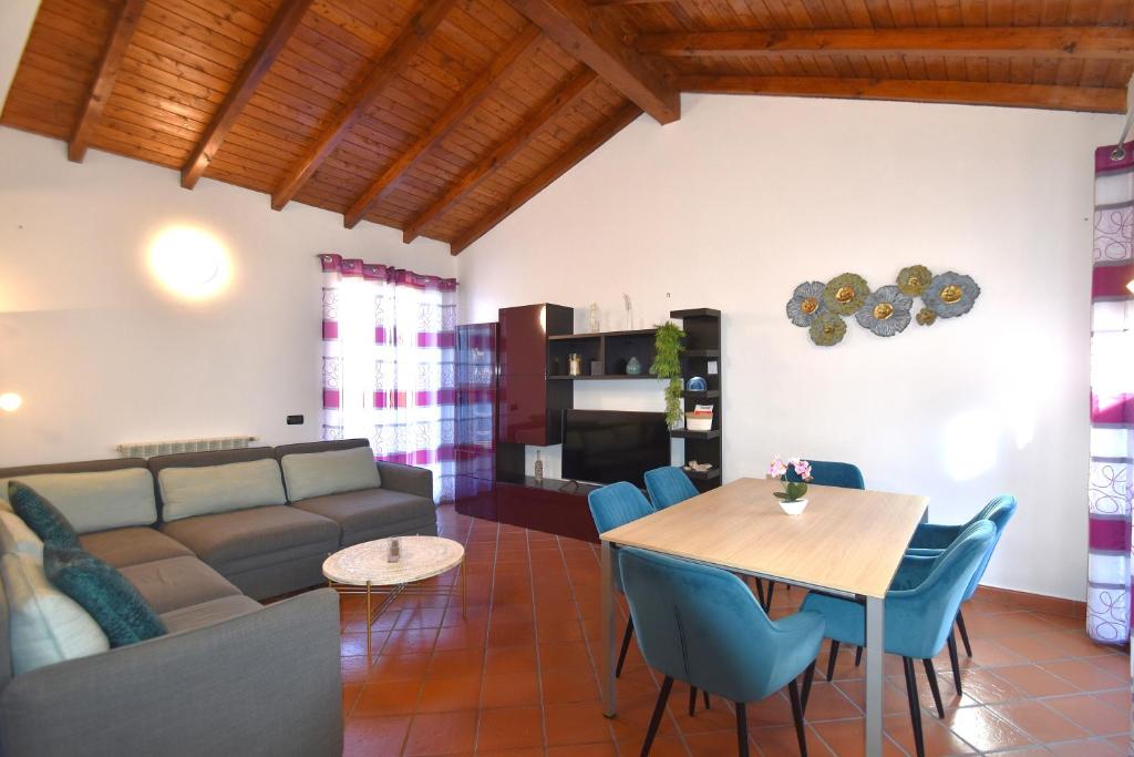 a living room with a couch and a table and chairs at Shila House in Luino