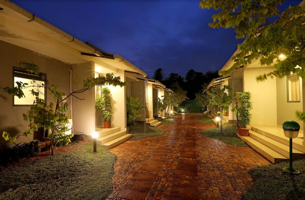 a cobblestone street with a row of houses at night at B Town Resort Near Infopark Kakkanad in Kakkanad