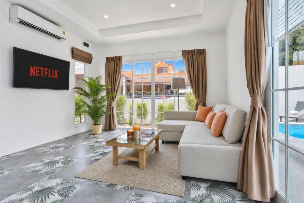 a living room with a couch and a table at Luxury Pool Villa Pattaya Center C3- 3 Bedroom in Pattaya South