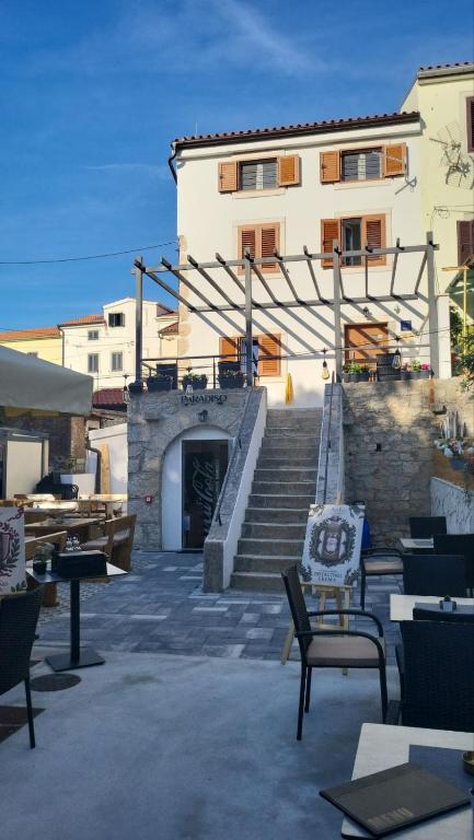 a building with a staircase leading to a building at LUXURY Rooms Punat in Punat