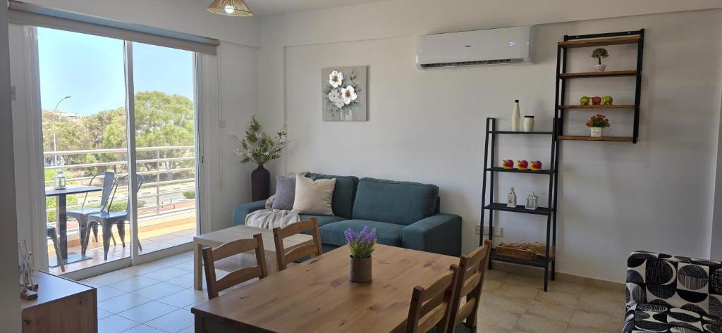 a living room with a table and a couch at Carisa Lighthouse by Staycom in Perivolia