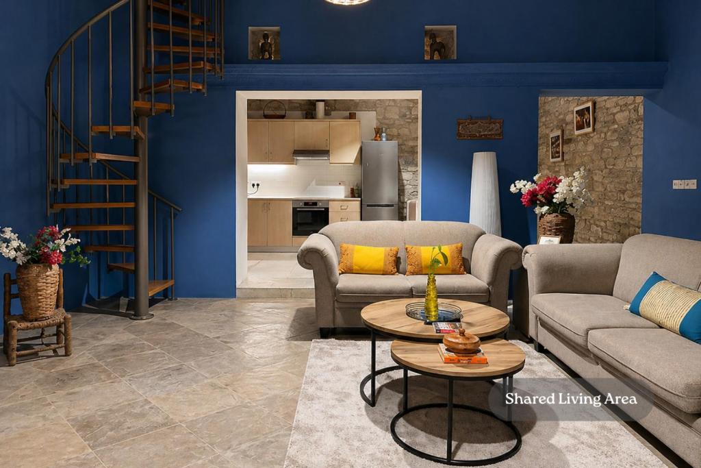 a living room with two couches and a table at Four Stories Lefkara in Pano Lefkara