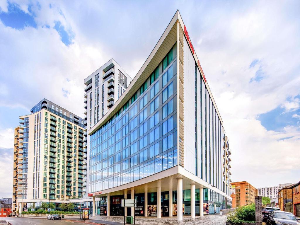 a rendering of a building with two tall buildings at ibis London Sutton Point in Sutton