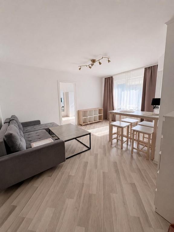 a living room with a couch and a table at Kerese tn Apartment 1-2 persons in Narva