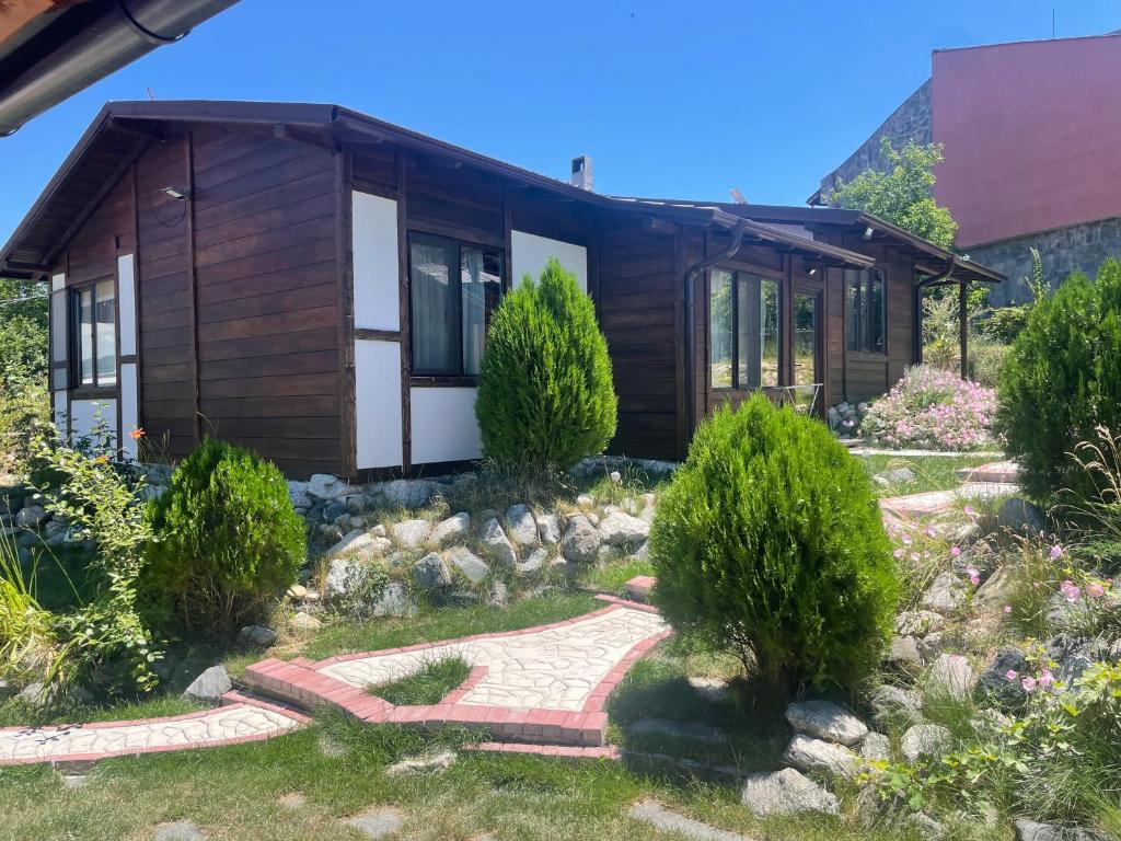 a house with a garden in front of it at Тихият кът in Sapareva Banya