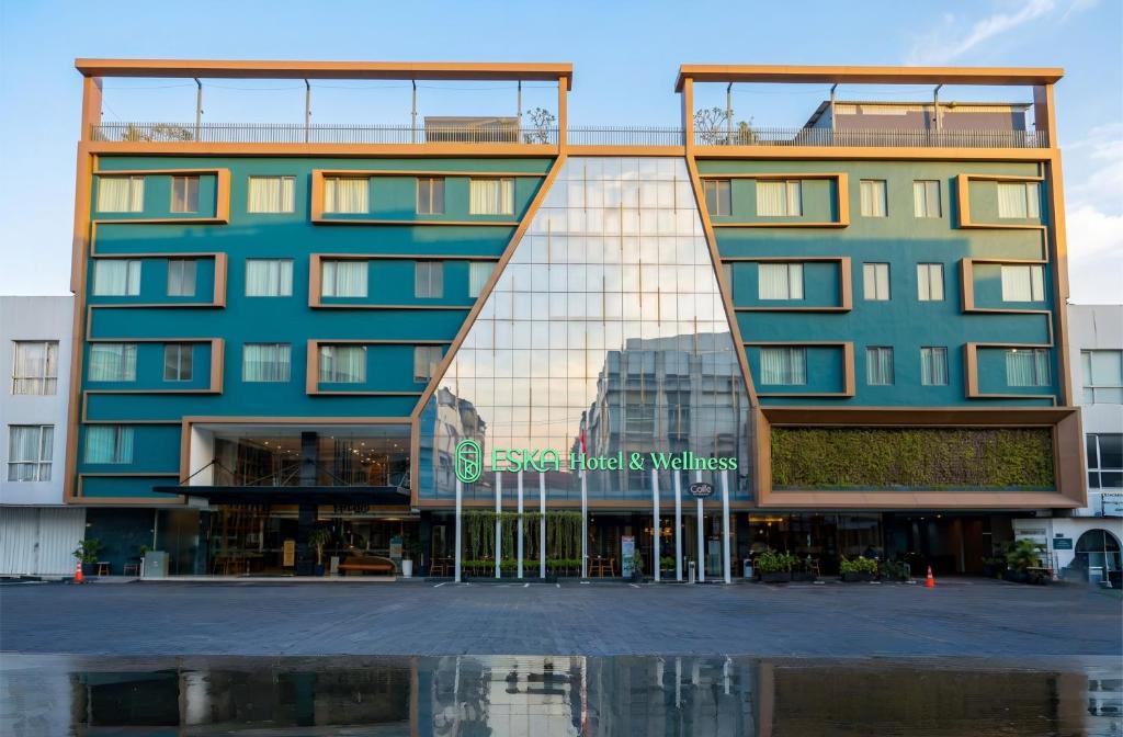 a building with a reflection in the water at ESKA Hotel in Batam Center